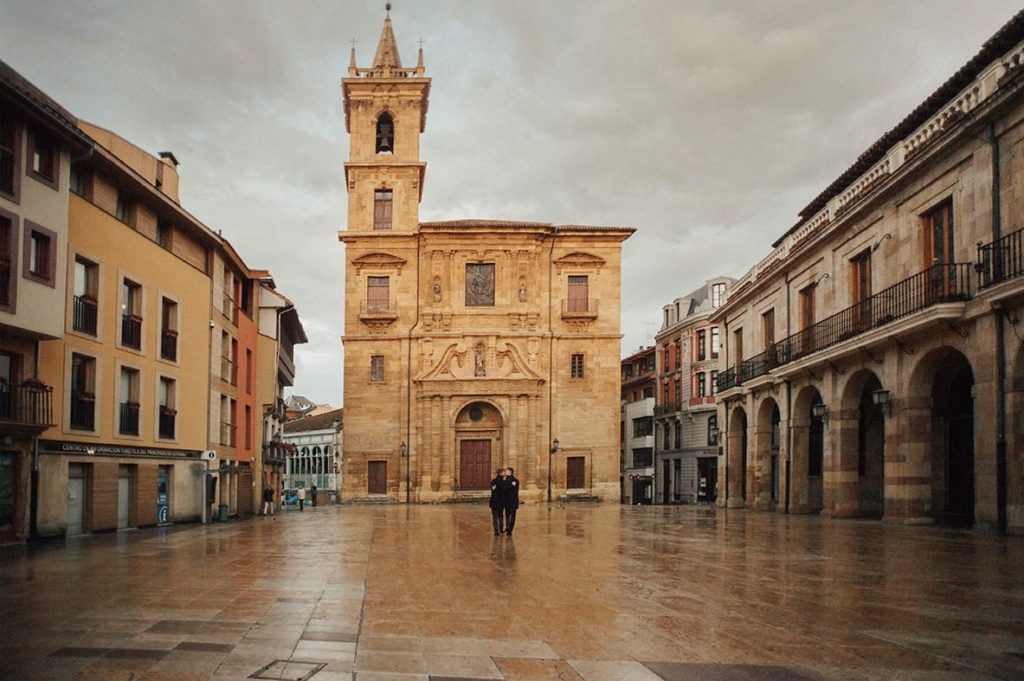 Gay couple walking in Oviedo's square