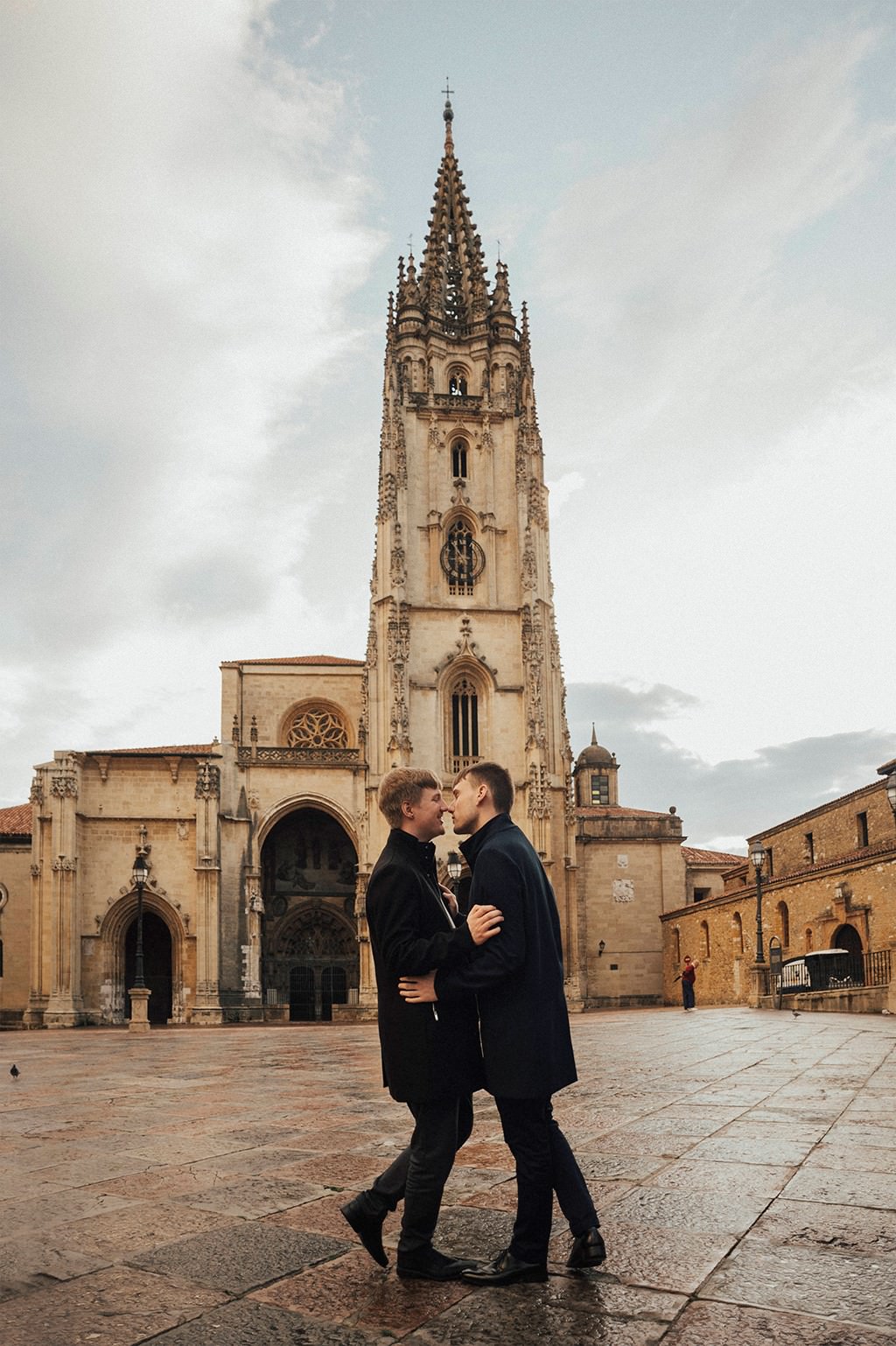 Gay couple cuddling in Oviedo's square