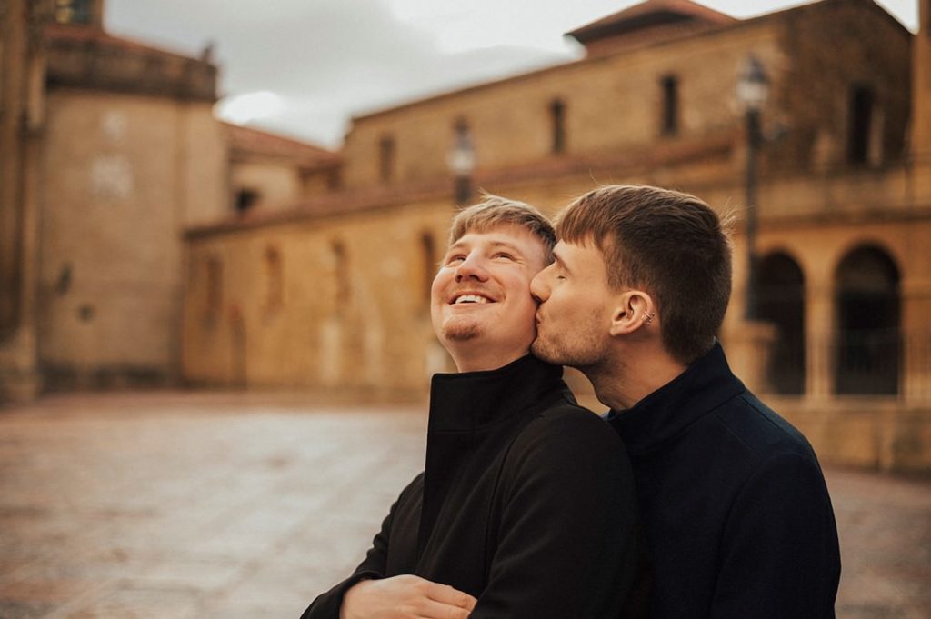 Gay couple cuddling in Oviedo's square
