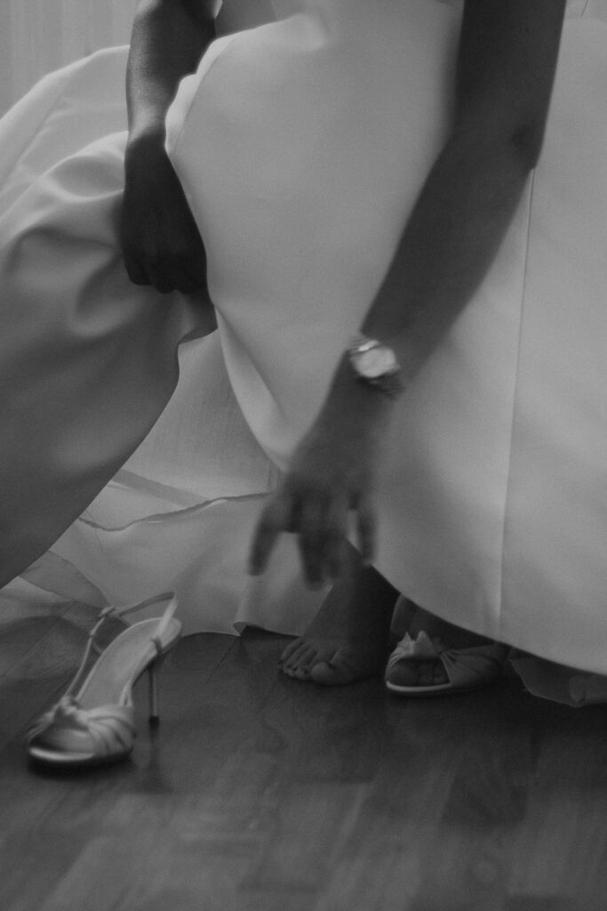 Bride putting her shoes on