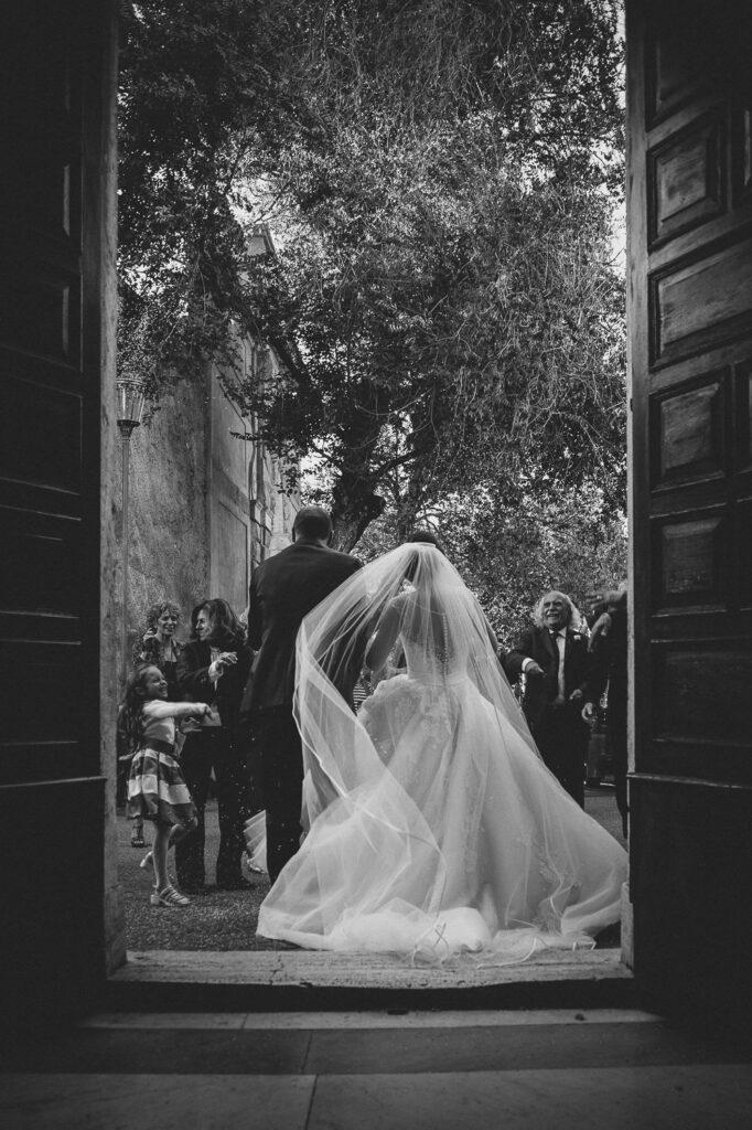 The bride dress out of the church with the wind